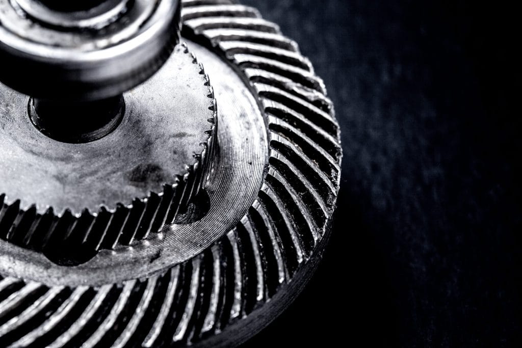 Close-up of metal differential gears with spiral teeth showing precision machining and industrial engineering detail